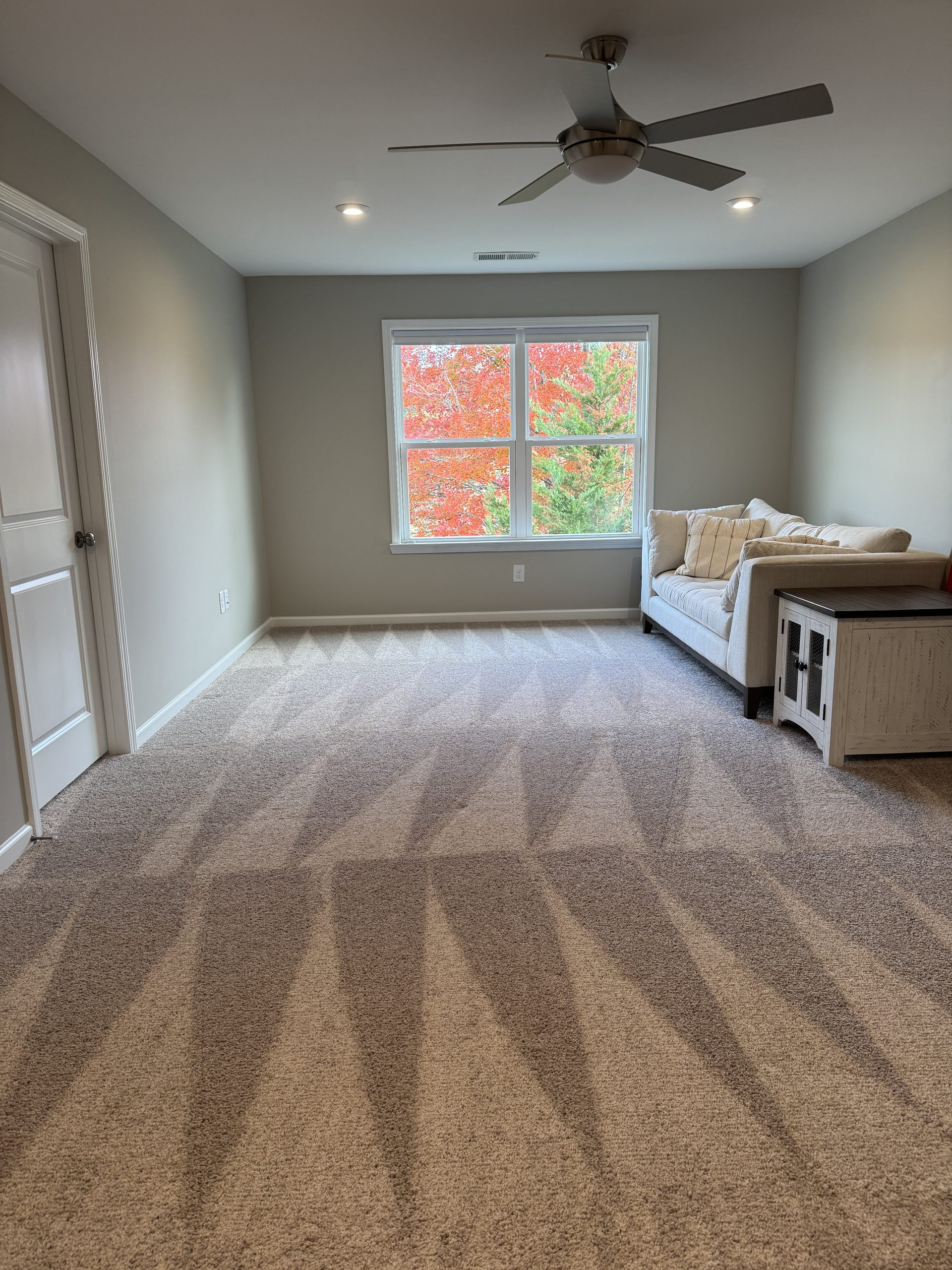 Freshly cleaned bedroom with vacuum lines on the carpet in a North Atlanta home